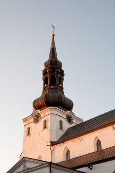 An old white tower with black roof and blue sky in Tallin

