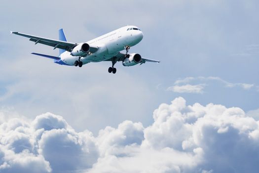 Passenger airliner flying over the clouds