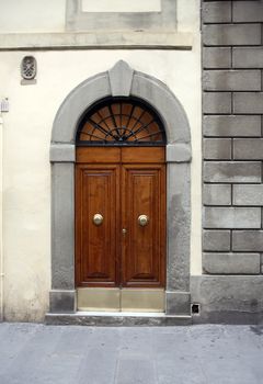 Fragment of old stone building with nice wooden door