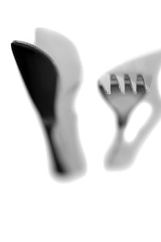 knife and fork with shadows isolated against a white background