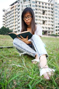 Asian girl reading in university