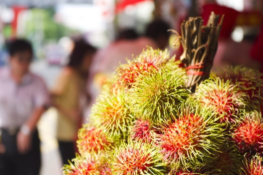 rambutan fruits on sale in asia street, exotic tropical fruit.