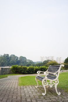 Empty bench in a park, to convey a feeling of waiting or expecting for the future or time passing.
