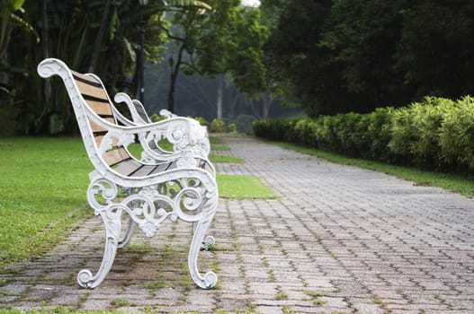 Empty bench in a park, nobody is around as time passing.