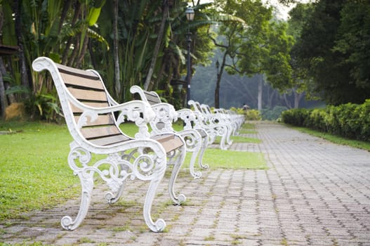 Empty bench in a park, nobody is around as time passing.
