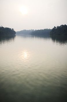 sun reflection on a lake, in a hazy day