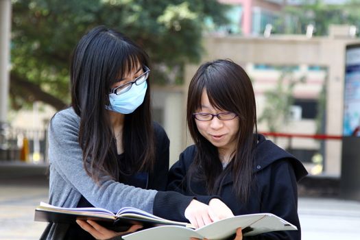 Asian students studying and discussing in university