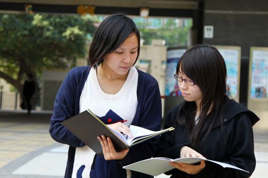 Asian students studying and discussing in university