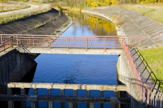 River dam and reflections on water background.