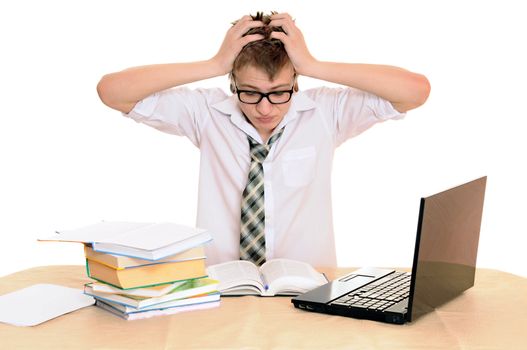 teenager student sits behind a desk isolated on white background