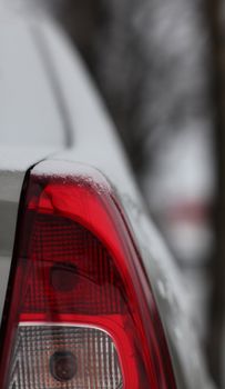 fragment of the car, rear view, stop signal, snow ice freezing speed