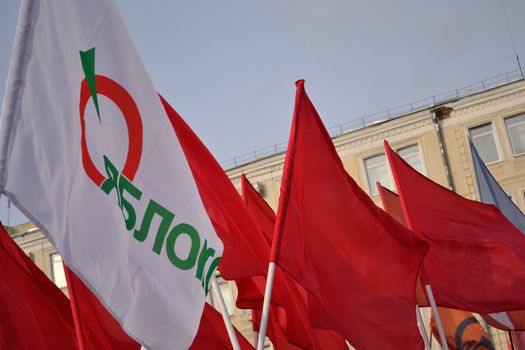 Waving flag of Russian Communistic party and Russian Democratic party “Yabloko” in time of processing for the fair elections. Moscow, February 4th, 2012