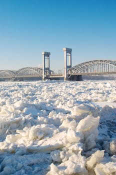 Bridge over frozen river in sunny day