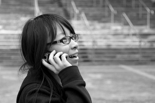 Asian woman using mobile phone and talking