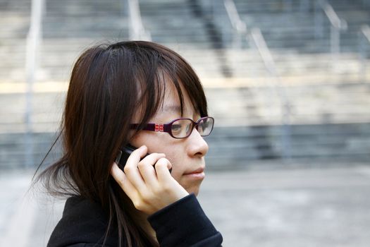 Asian woman using mobile phone and talking