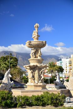 The historic fountain in the center of Estepona, avenue, between sea and mountains