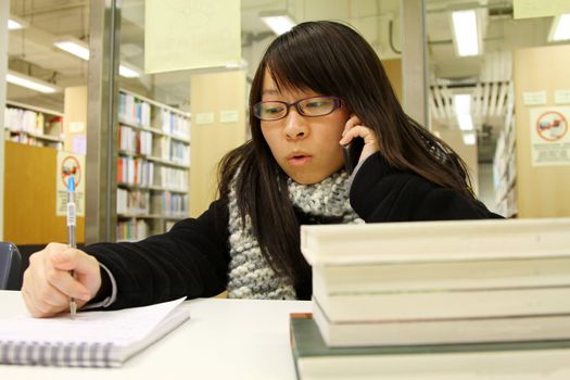 Asian woman using mobile phone and talking