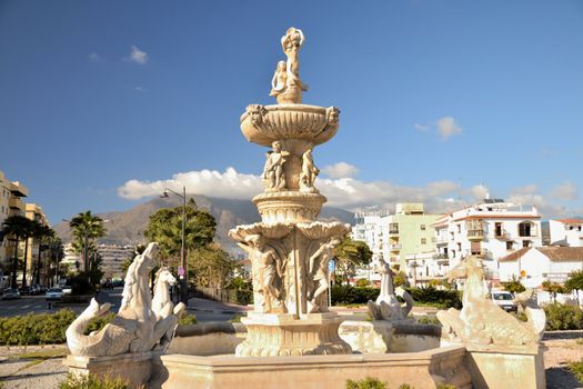 The historic fountain in the center of Estepona, avenue, between sea and mountains