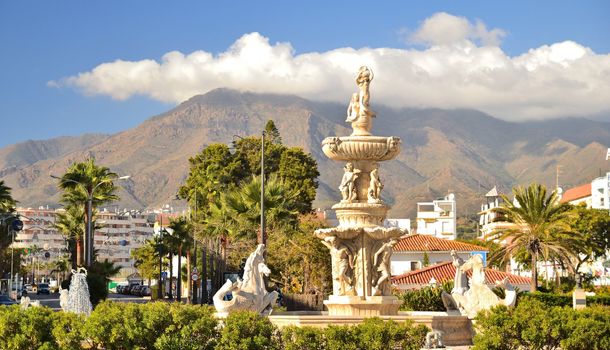 The historic fountain in the center of Estepona, avenue, between sea and mountains