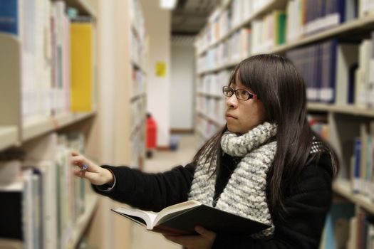 Asian university student in library