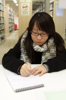 Asian university student in library