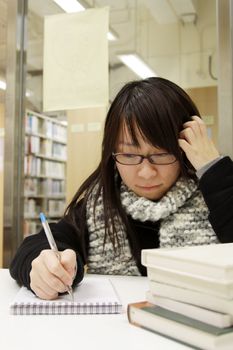 Asian university student in library