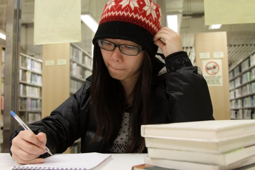 Asian woman studying in library