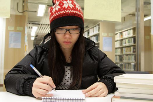 Asian woman studying in library