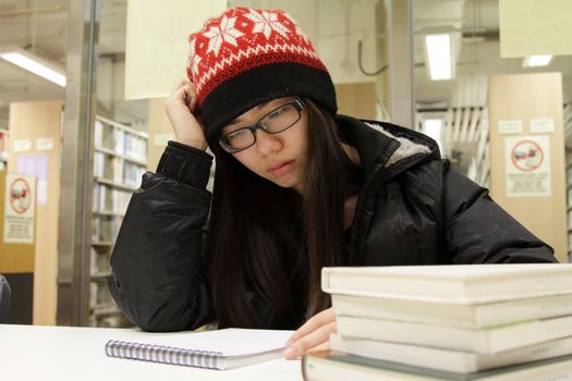 Asian woman studying in library