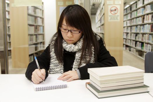 Asian woman studying in library