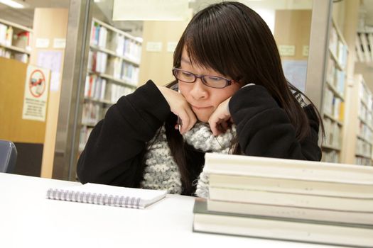 Asian woman studying in library