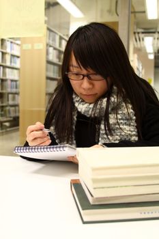 Asian woman studying hard in a university