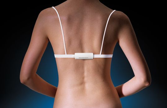 back of woman with technological white brassiere and electronic device with path