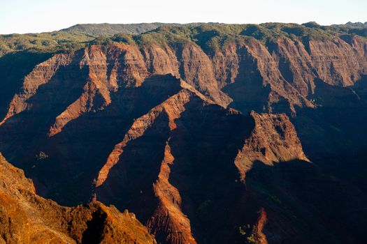 Early light illuminates the steep rock sides of Waimea Canyone on Kauai