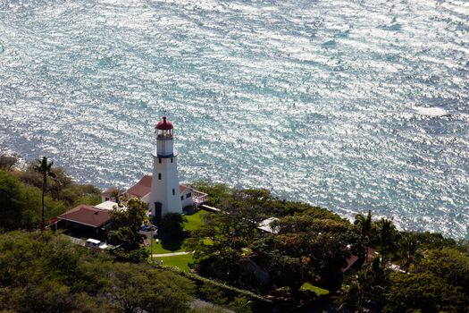 Lighthouse on coast under the summit of the old volcano of Diamond Head