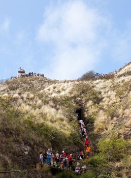 Waikiki, HI - JANUARY 15: Tourists climbing to summit of Diamond Head crater on January 15, 2012. The path gains 560 feet from the crater floor.