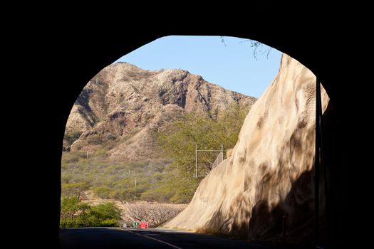 Road emerging from tunnel entering Diamond Head crater in Waikiki Hawaii