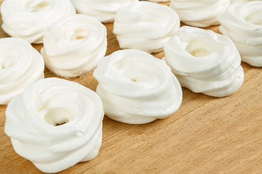 close up of homemade white very sweet baked, candy on wooden background