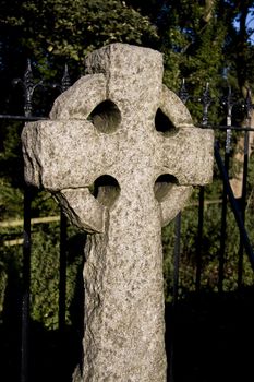 roughly-cut stone cross on cemetery in stirling