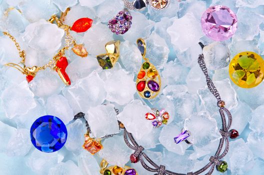 Jewels at blue cube of ice background