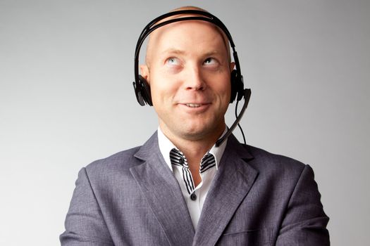 Portrait of a young handsome man with a headset on his head, who works in customer service