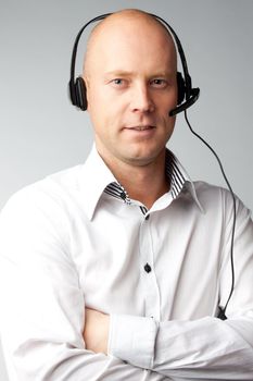 Portrait of a young handsome man with a headset on his head, who works in customer service