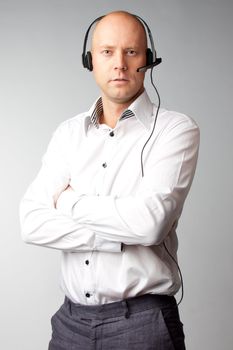 Portrait of a young handsome man with a headset on his head, who works in customer service