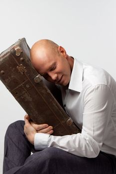 Portrait of a man with an old suitcase