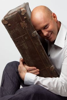 Portrait of a man with an old suitcase