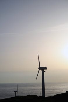 a windmill over a mountain