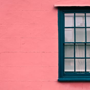 Green sash window in a classic suffolk pink wall