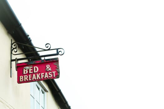 Bed and breakfast sign on a traditional english cottage with a white background