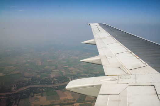 Earth and wing of an airplane flying