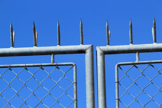Close up of iron grey fence in blue byckground